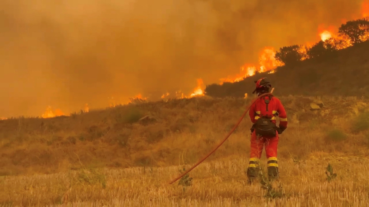 A member of Spain's Military Emergency Unit (UME) works to extinguish a wildfire, in Uncastillo, Spain, in this screengrab taken from a handout video released July 16, 2026. Spanish Military Emergency Unit/Handout via REUTERS