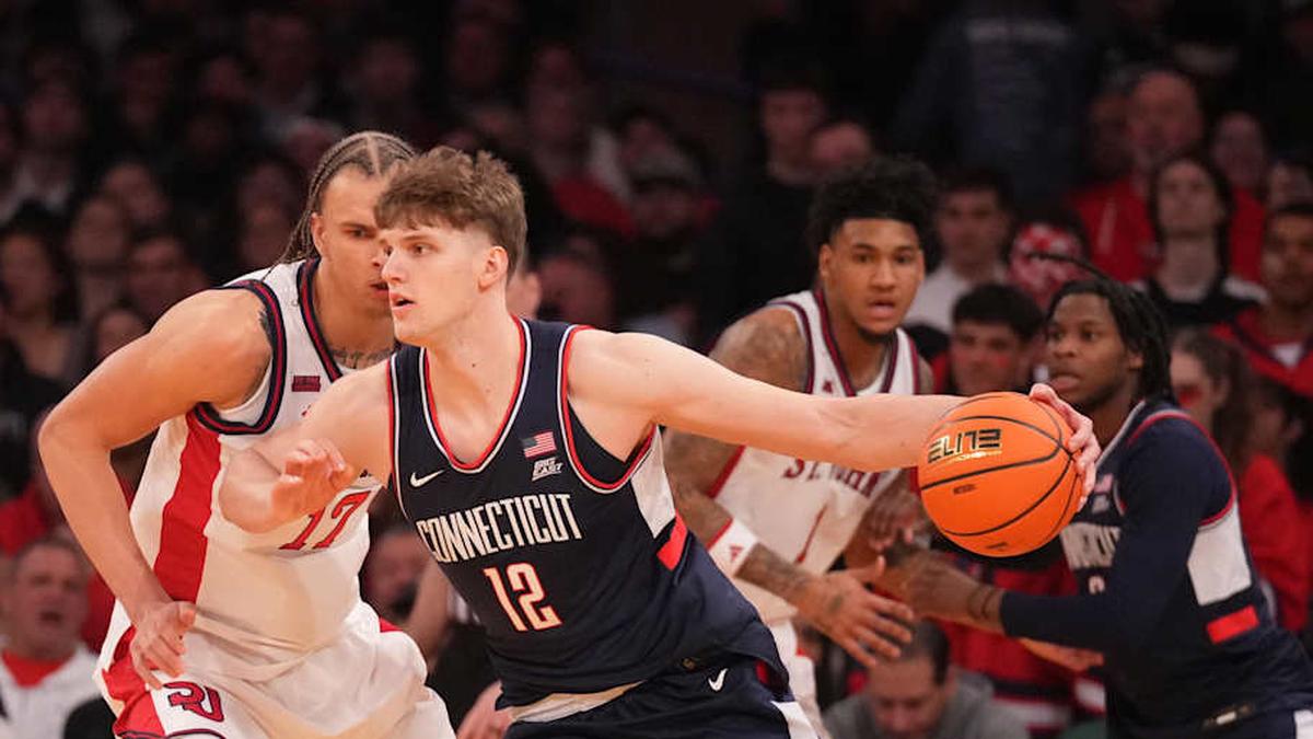  Mar 14, 2026; New York, NY, USA; Connecticut Huskies center Eric Reibe (12) works around St. John's Red Storm forward Rubén Prey (17) during the first half of the men's Big East Conference Tournament Championship at Madison Square Garden. Mandatory Credit: Robert Deutsch-Imagn Images | Robert Deutsch-Imagn Images 