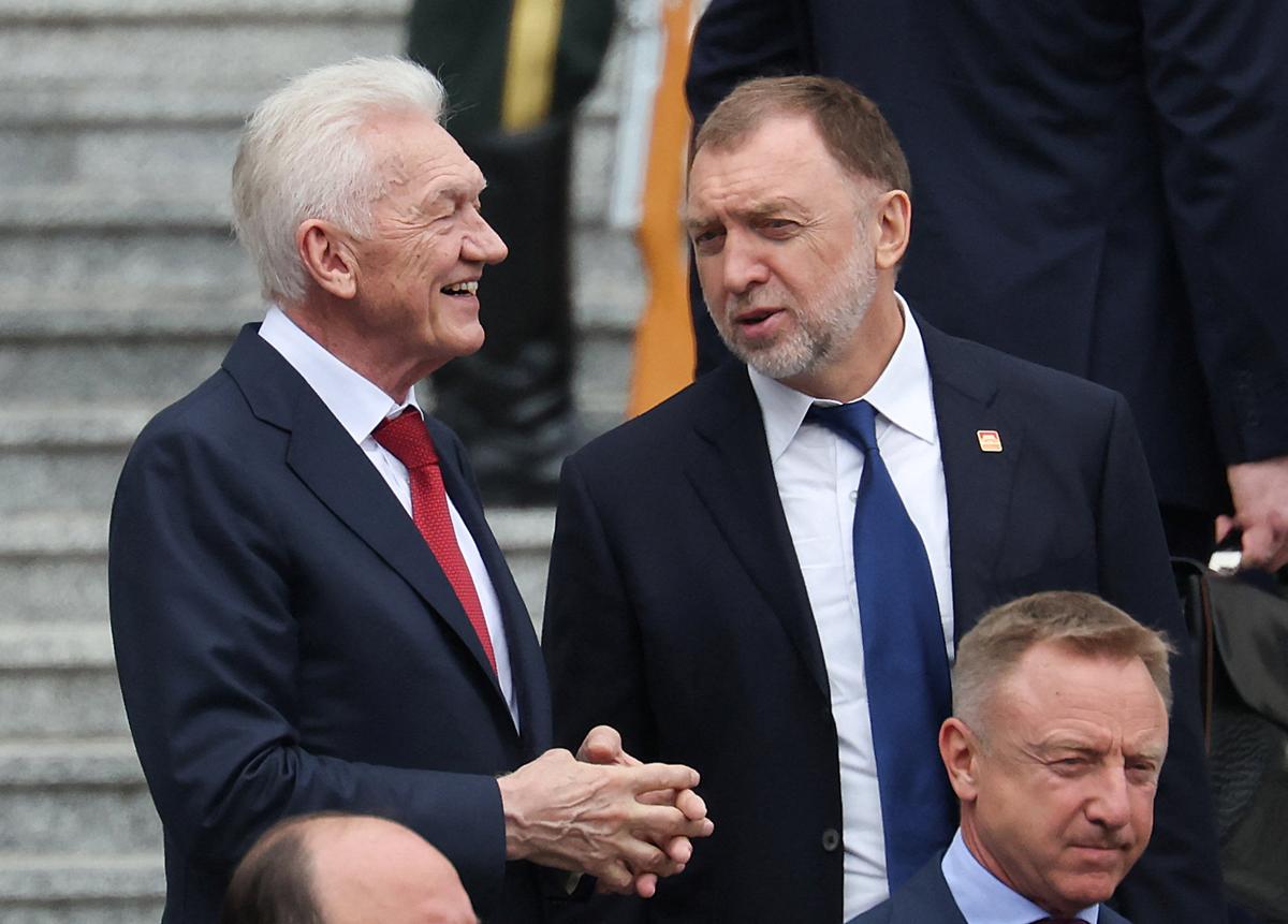 Russian businessmen Gennady Timchenko and Oleg Deripaska chat as they walk down the stairs of the Great Hall of the People in Beijing together with other delegation members ahead of the welcome ceremony during Russian President Vladimir Putin visit to China, May 20, 2026. REUTERS/Maxim Shemetov/Pool