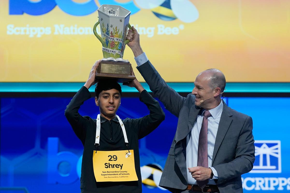  E.W. Scripps Company President and CEO Adam Symson, right, helps hold the trophy over Shrey Parikh, 14, winner of the 2026 Scripps National Spelling Bee, at DAR Constitution Hall on Thursday night in Washington, D.C. (AP Photo/Jose Luis Magana) 