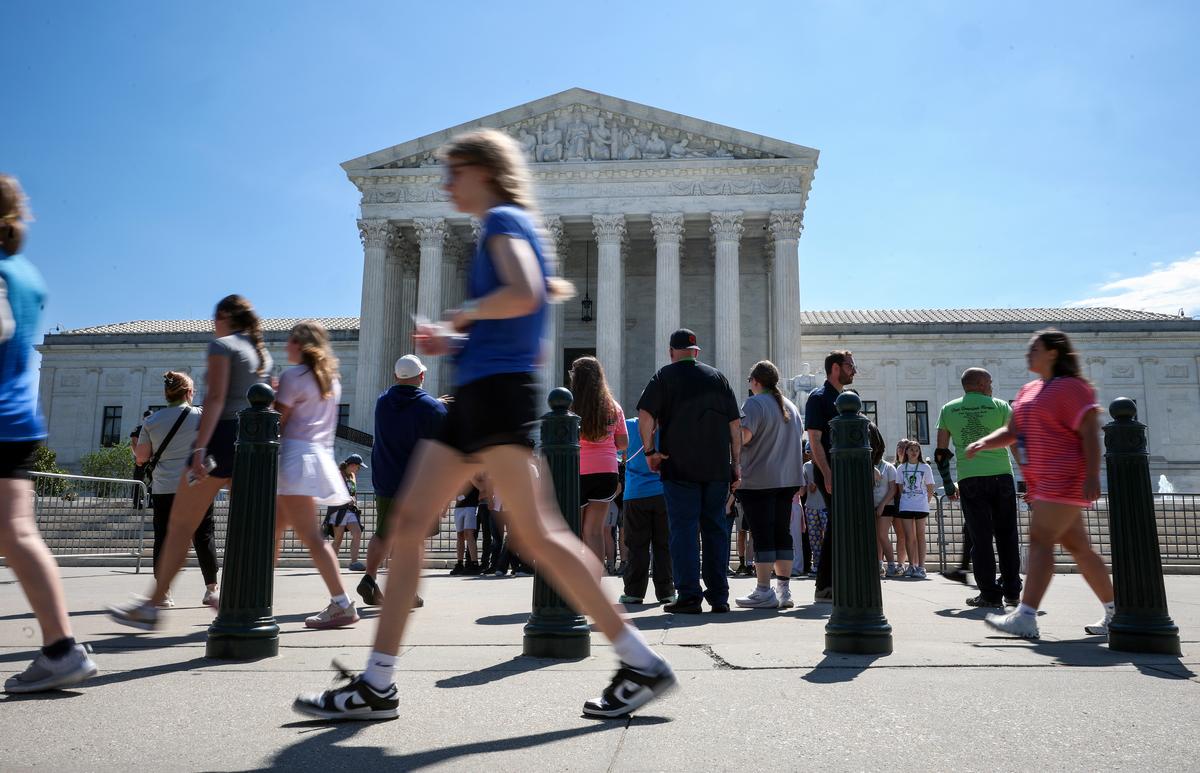  Pedestrians walk past the U.S. Supreme Court on May 28, 2026, in Washington, DC. 
