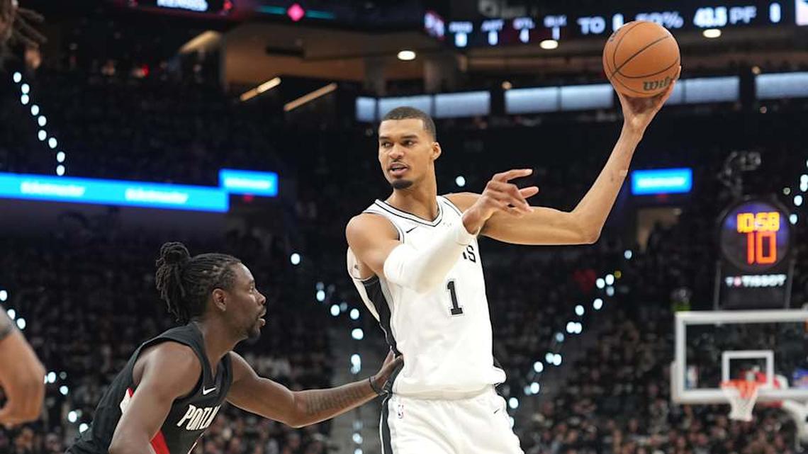  Apr 21, 2026; San Antonio, Texas, USA; San Antonio Spurs forward Victor Wembanyama (1) looks to pass against Portland Trail Blazers guard Jrue Holiday (5) during the first half of game two of the first round of the 2026 NBA Playoffs at Frost Bank Center. | Scott Wachter-Imagn Images 