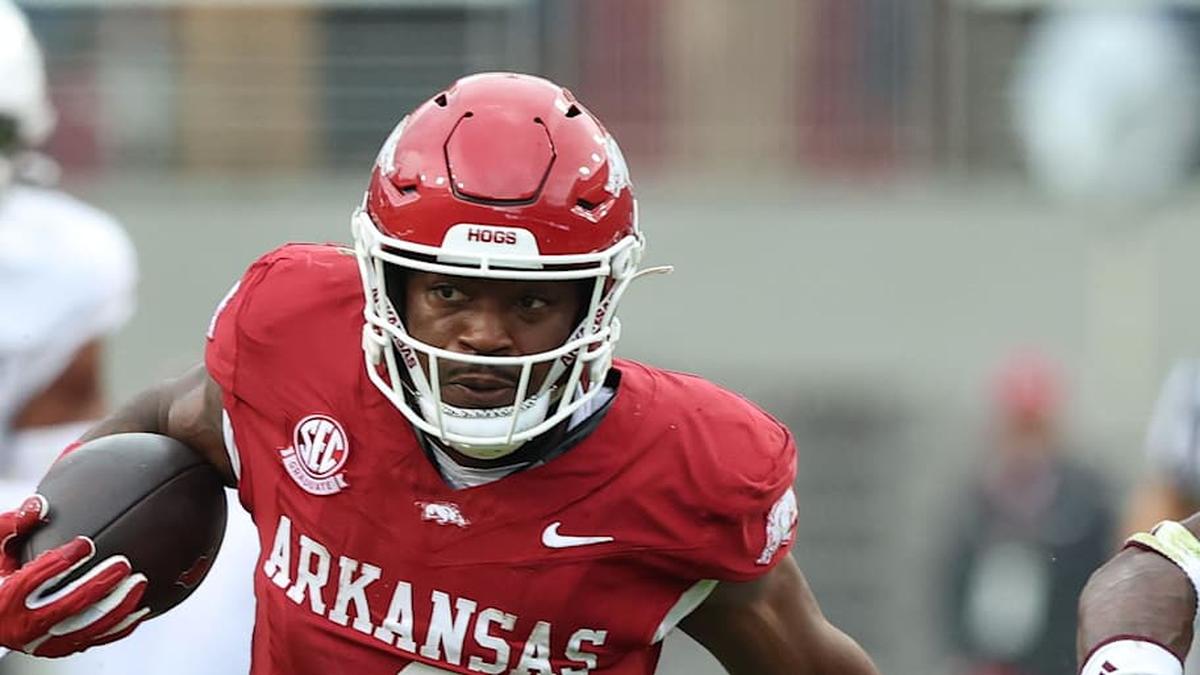  Oct 18, 2025; Fayetteville, Arkansas, USA; Arkansas Razorbacks running back Mike Washington Jr (4) rushes in the second quarter as Texas A&M Aggies cornerback Tyreek Chappell (7) and safety Dalton Brooks (25) defend at Donald W. Reynolds Razorback Stadium. Mandatory Credit: Nelson Chenault-Imagn Images | Nelson Chenault-Imagn Images 