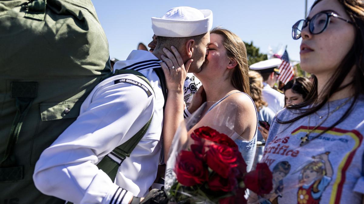 Aviation Support Equipment Technician Second Class Petty Officer Stephen Smith shares a kiss with his wife, Amanda, after disembarking from the USS Gerald R. Ford at Naval Station Norfolk following an 11-month deployment, on Saturday, May 16, 2026, in Norfolk, Virginia. (Kendall Warner/The Virginian-Pilot/TNS)