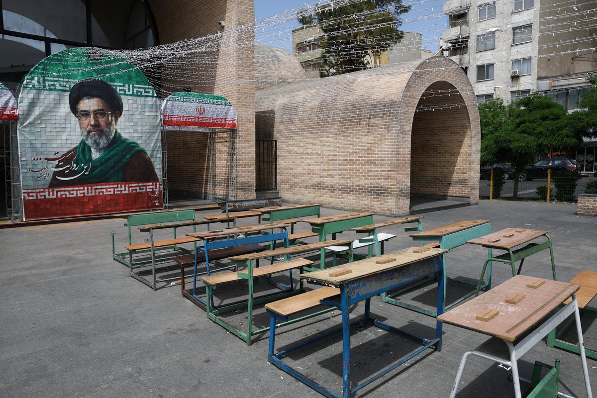 A banner with a picture of Iran's new Supreme Leader, Mojtaba Khamenei, next to a symbolic classroom of the Minab school students who were killed in a strike, in Tehran, Iran, May 8, 2026. Majid Asgaripour/WANA (West Asia News Agency) via REUTERS