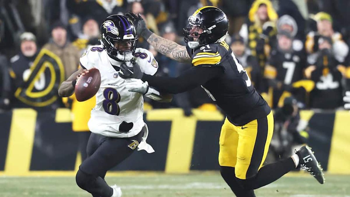  Jan 4, 2026; Pittsburgh, Pennsylvania, USA; Baltimore Ravens quarterback Lamar Jackson (8) scrambles with the ball as Pittsburgh Steelers linebacker Nick Herbig (51) cases during the fourth quarter at Acrisure Stadium. Mandatory Credit: Charles LeClaire-Imagn Images | Charles LeClaire-Imagn Images 