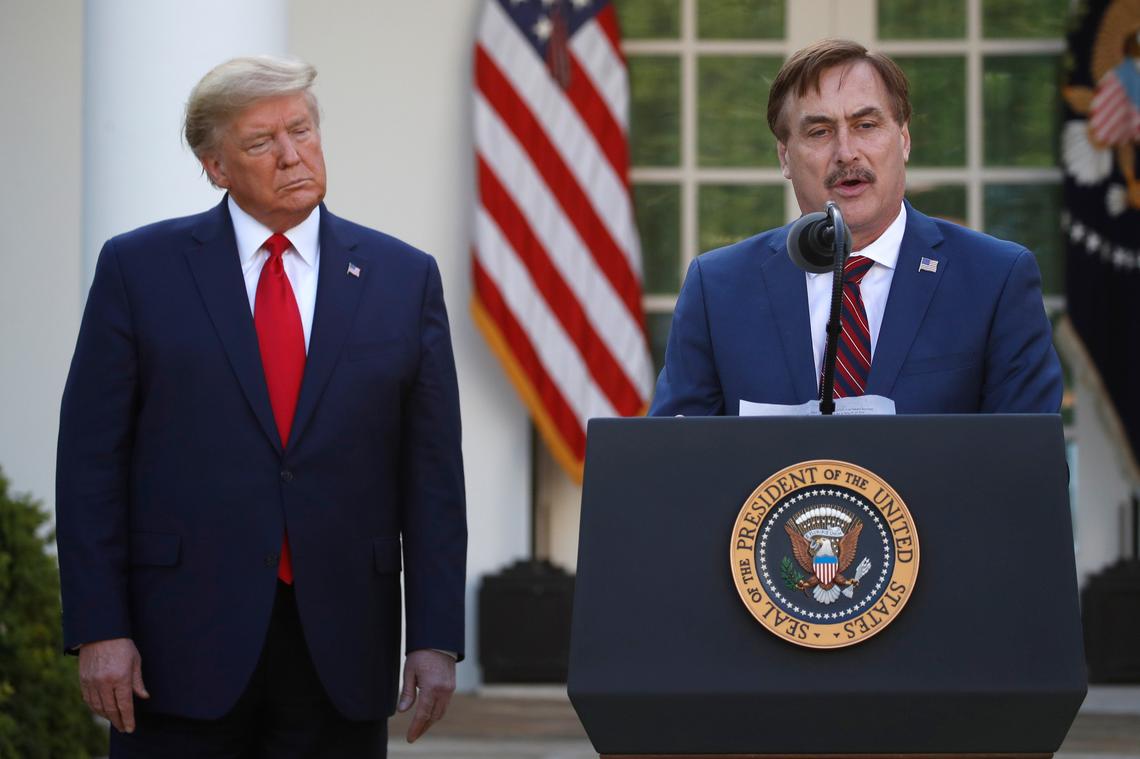 FILE - In this March 30, 2020 file photo, My Pillow CEO Mike Lindell speaks as President Donald Trump listens during a briefing about the coronavirus in the Rose Garden of the White House, in Washington.