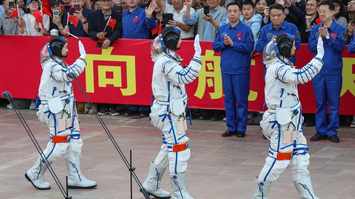 Astronauts Zhu Yangzhu, Zhang Zhiyuan, and Lai Ka-ying, who is the first astronaut from Hong Kong, wave during a see-off ceremony before taking part in the Shenzhou-23 spaceflight mission to China's Tiangong space station, at Jiuquan Satellite Launch Center, near Jiuquan, Gansu province, China, May 24, 2026. REUTERS/Maxim Shemetov