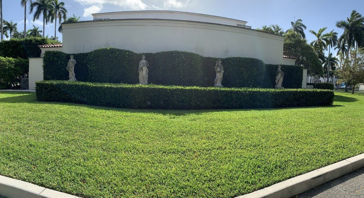 Four classical statues depicting the seasons stand outside the Esther B. O’Keeffe Building at the Society of the Four Arts in Palm Beach before their removal.