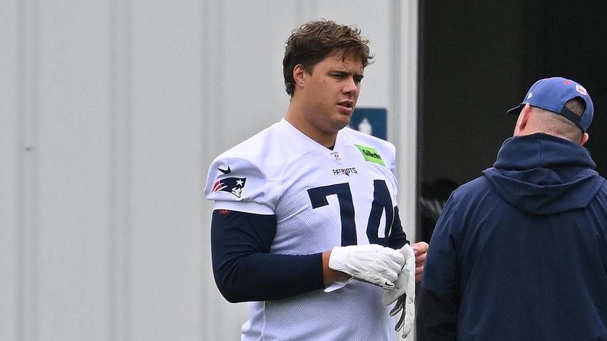  May 9, 2026; Foxborough, MA, USA; New England Patriots rookie tackle Caleb Lomu (74) talks to a member of the coaching staff at the New England Patriots rookie camp at Gillette Stadium. Mandatory Credit: Eric Canha-Imagn Images | Eric Canha-Imagn Images 