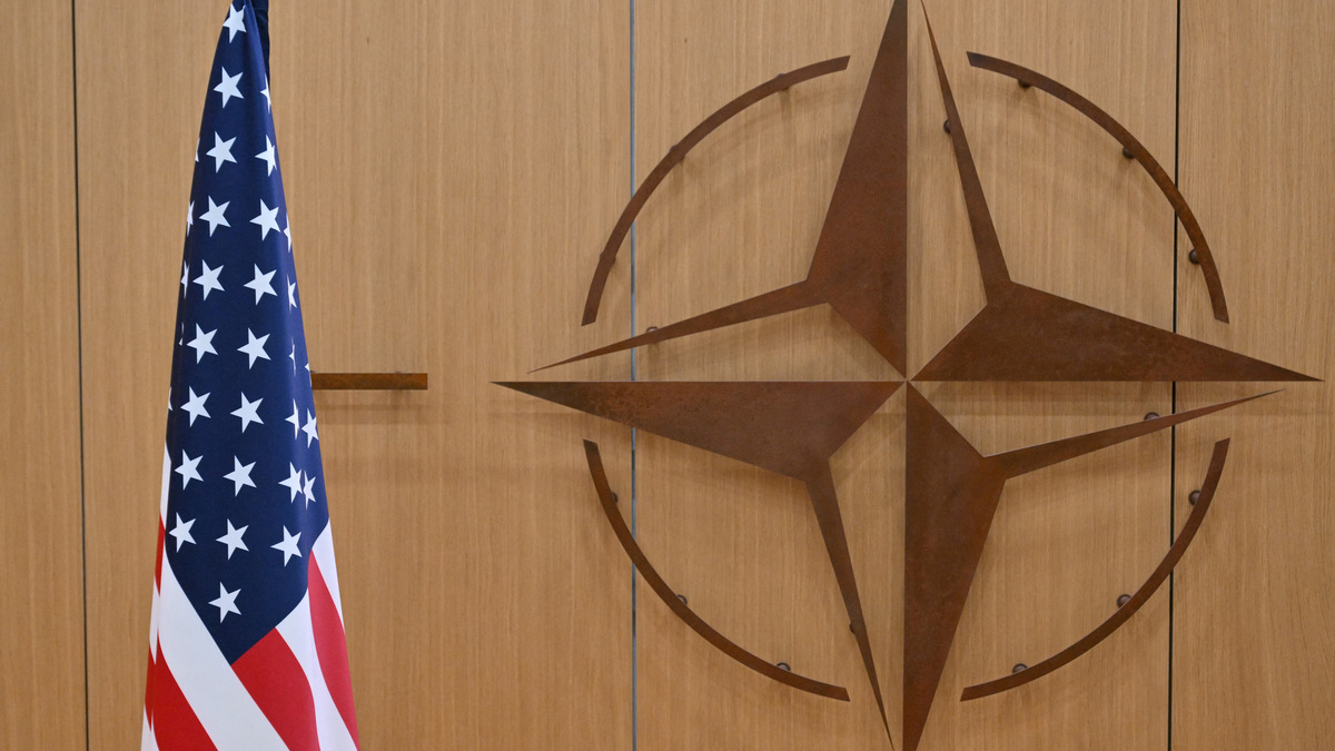 This photo shows the logo of the North Atlantic Treaty Organisation (NATO) and the US flag at NATO headquarters in Brussels, Belgium on February 17, 2025.     NICOLAS TUCAT/Pool via REUTERS