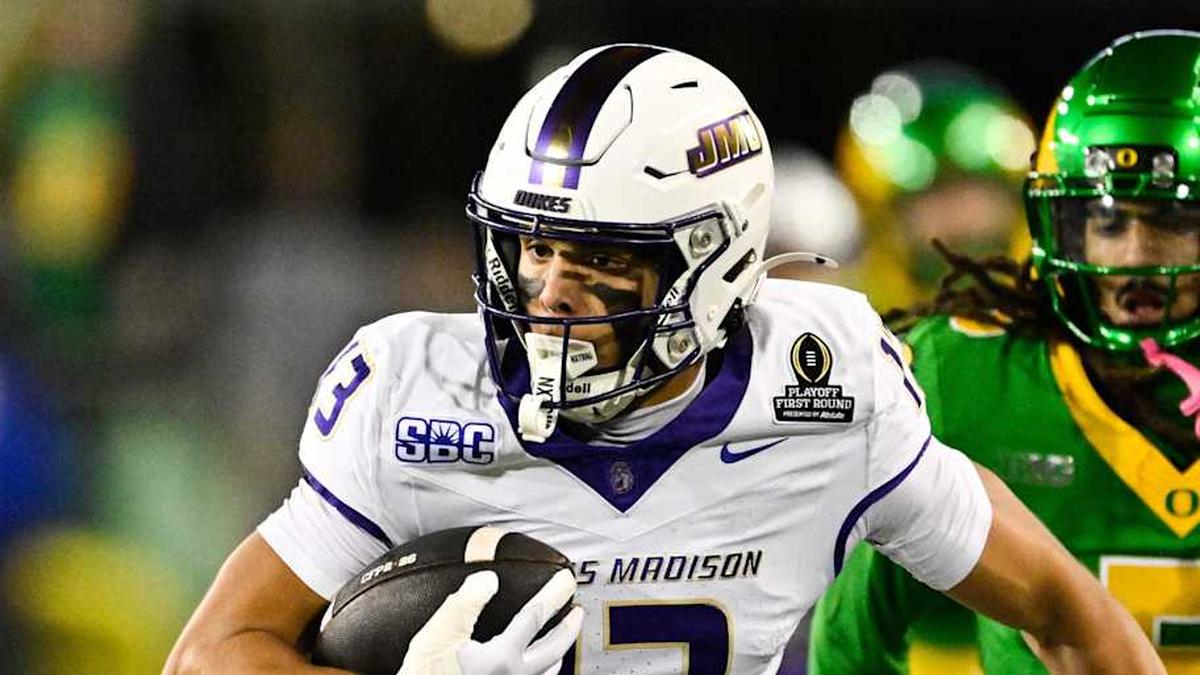  Dec 20, 2025; Eugene, OR, USA; James Madison Dukes wide receiver Landon Ellis (13) runs after making a catch as Oregon Ducks defensive back Theran Johnson (5) defends during the second quarter at Autzen Stadium. Mandatory Credit: Troy Wayrynen-Imagn Images | Troy Wayrynen-Imagn Images 
