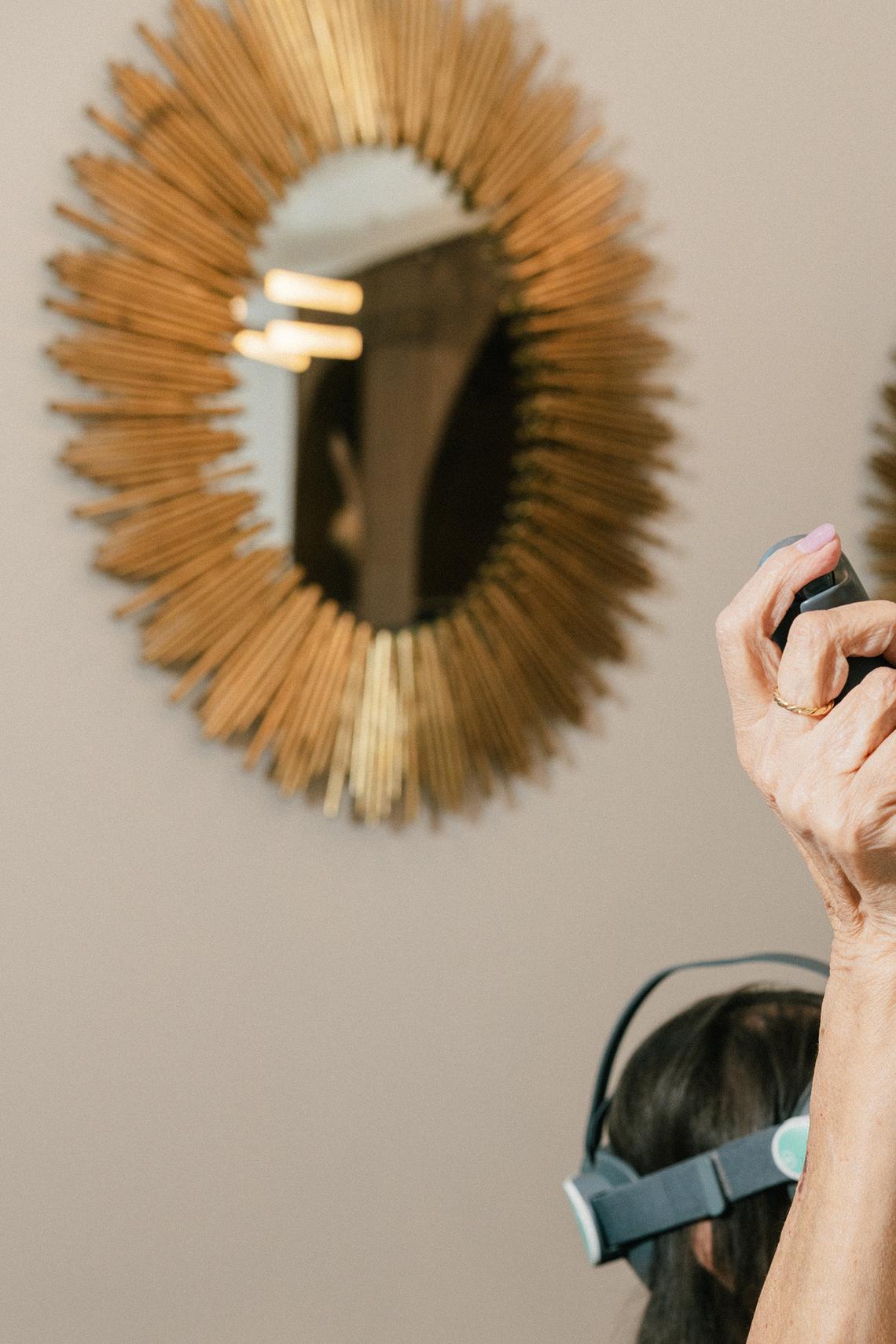 Mary Sue Escamilla plays a ballon popping game with a VR headset in the multi-purpose library at Castle Argyle in Los Angeles, Feb. 2, 2026. New tools tailored for use in senior living communities allow for shared experiences and social bonding. (Morgan Lieberman/The New York Times)