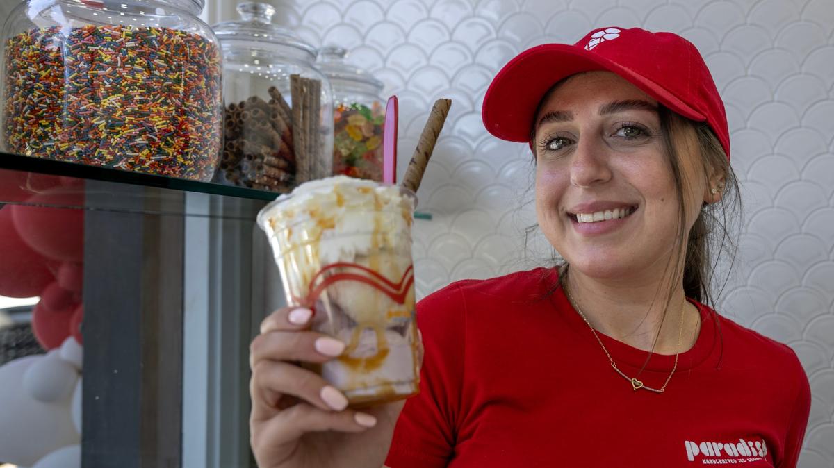 Paradis Ice Cream server, Karla Kassis, serves up a sundae and a waffle bowl at the new Old Towne Orange circle location on Wednesday, May 6, 2026. The shop replaces the former Plaza Barbershop. (Photo by Mindy Schauer, Orange County Register/SCNG)
