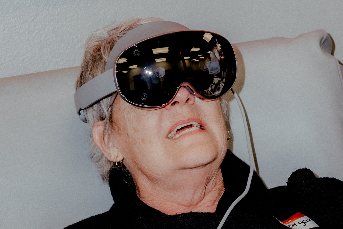 Margaret Wiegel, who gives blood as often as every three weeks, tests out Abbott's mixed-reality games while donating in Bloomingdale, Ill., June 8, 2026. Abbott commissioned the Chicago Symphony Orchestra -- widely considered one of the world's great orchestras -- to record their games' soundtracks in a whirlwind, one-day recording session in the spring. (Evan Jenkins/The New York Times)