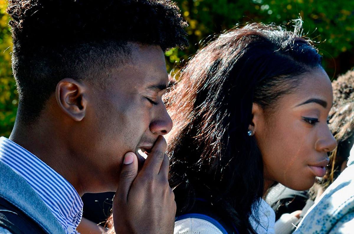Members of the Legion of Black Collegians and supporters of Concerned Student 1950 share an emotional moment on Nov. 7, 2015, after an on-campus protest. The students voiced their concerns and told stories of racism on campus.