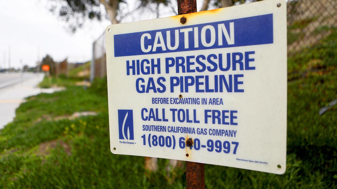 A warning sign for a gas pipeline is mounted near the Scattergood Generating Station on Feb. 12, 2019, in El Segundo, California. The gas-fired power plant operates in one of the communities most affected by pollution in California, according to state data. Los Angeles announced it will abandon plans to renovate three natural gas power plants including Scattergood as part of the state's push toward renewable energy. California lawmakers passed a bill last year requiring the state to obtain 100 percent of its electricity from clean sources by 2045. (Mario Tama/Getty Images/TNS)
