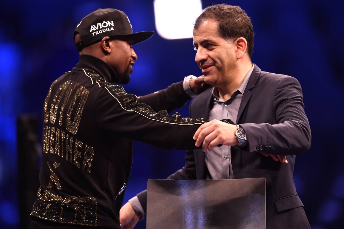  LAS VEGAS, NV - AUGUST 25: Floyd Mayweather Jr. (L) embraces Executive VP & General Manager of Showtime Sports Stephen Espinoza during a news conference after Mayweather's 10th-round TKO victory in their super welterweight boxing match on August 26, 2017 at T-Mobile Arena in Las Vegas, Nevada. (Photo by Jeff Bottari/Zuffa LLC/Zuffa LLC via Getty Images)