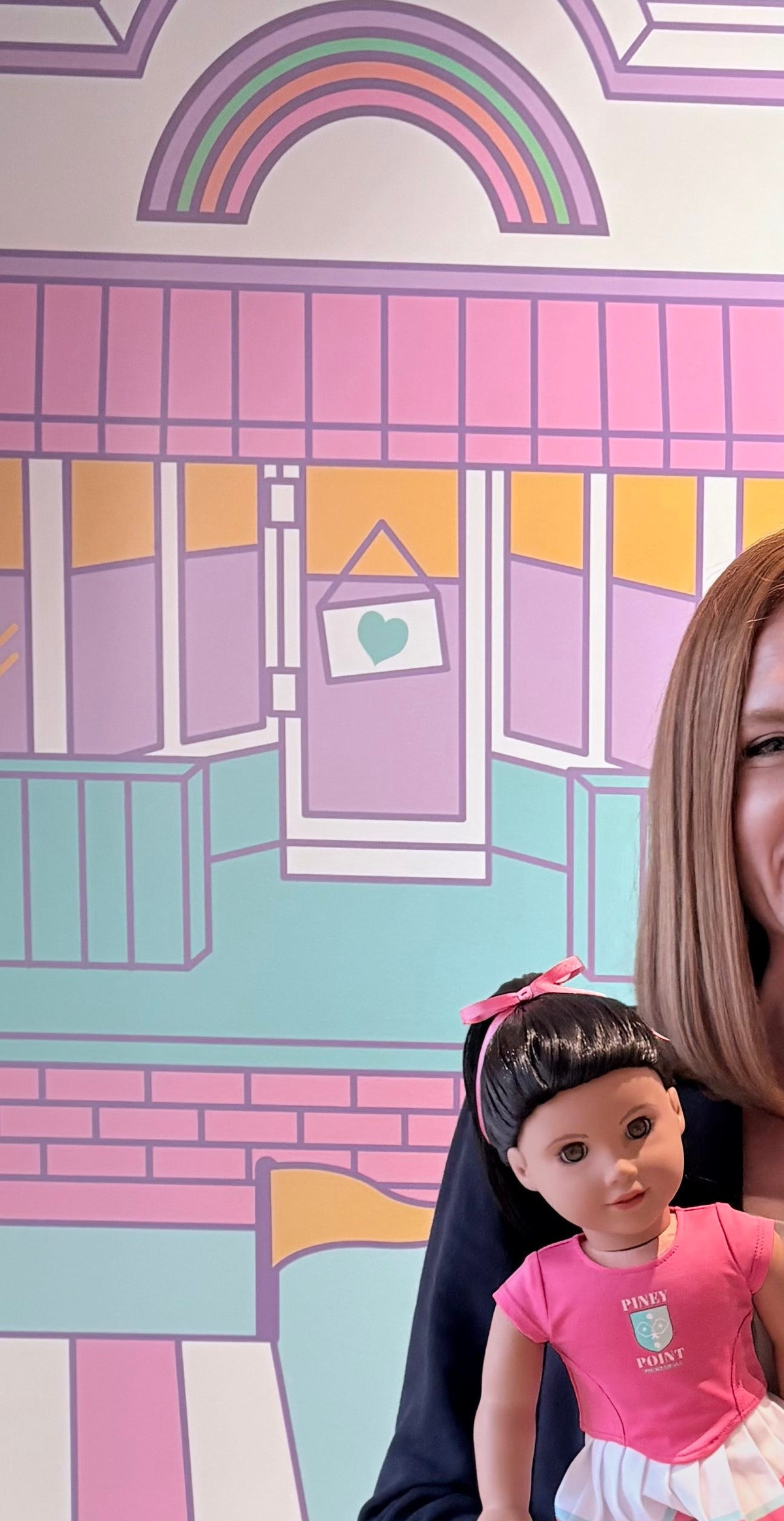 Kat Cartwright, a senior historical researcher at American Girl, holds the 2026 Girl of the Year Raquel Reyes, a descendent of the original historical doll Samantha Parkington.