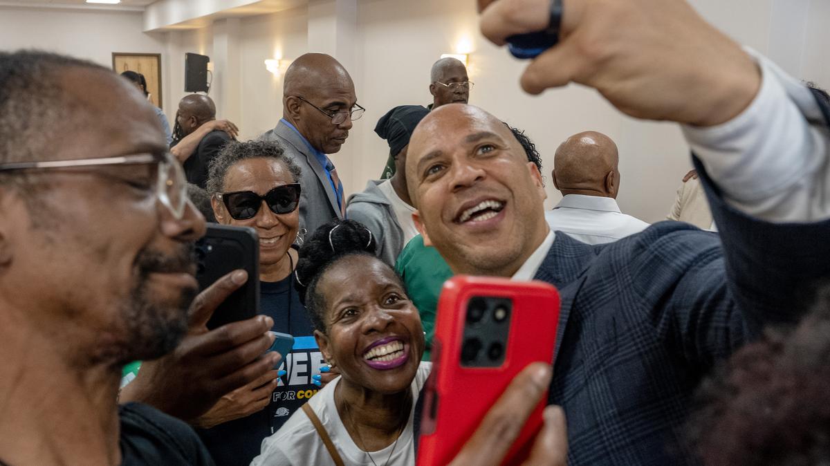 U.S. Sen. Cory Booker takes selfies with supporters following a get-out-the-vote rally for State Sen. Sharif Street at the Church of Christian Compassion in West Philadelphia on May 18, 2026. (Tom Gralish/The Philadelphia Inquirer/TNS)