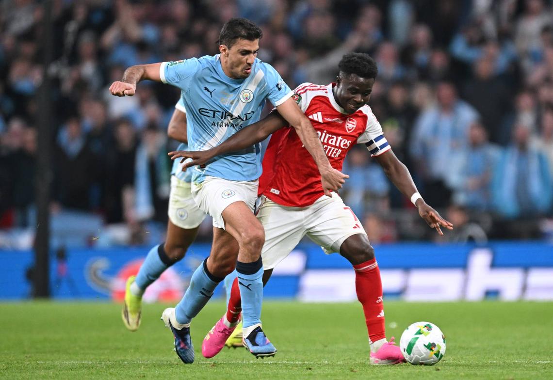  Bukayo Saka of Arsenal is challenged by Rodri of Manchester City during the Carabao Cup Final match between Arsenal and Manchester City at Wembley Stadium on March 22, 2026 in London, England. (Photo by Stuart MacFarlane/Arsenal FC via Getty Images) Photo by Stuart MacFarlane/Arsenal FC via Getty Images
