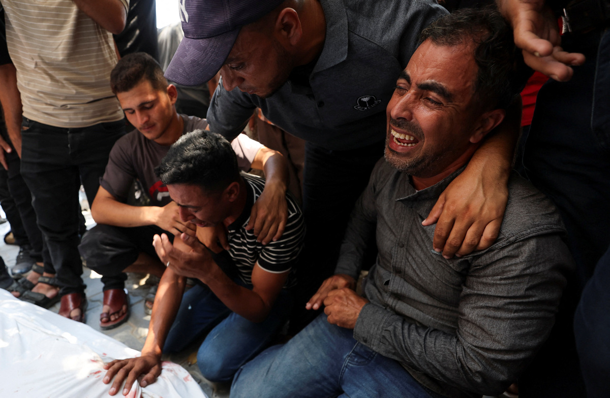 Mourners react during the funeral of six Palestinian police officers who were killed in an Israeli strike on a police station, according to medics, at Al Shifa Hospital in Gaza City, July 14, 2026. REUTERS/Dawoud Abu Alkas