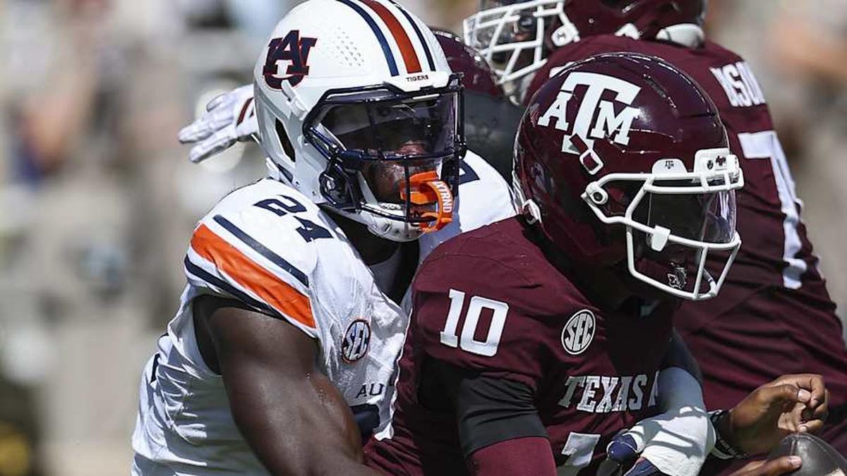  Sep 27, 2025; College Station, Texas, USA; Texas A&M Aggies quarterback Marcel Reed (10) is tackled by Auburn Tigers defensive end Keyron Crawford (24) during the second quarter at Kyle Field. Mandatory Credit: Troy Taormina-Imagn Images | Troy Taormina-Imagn Images 