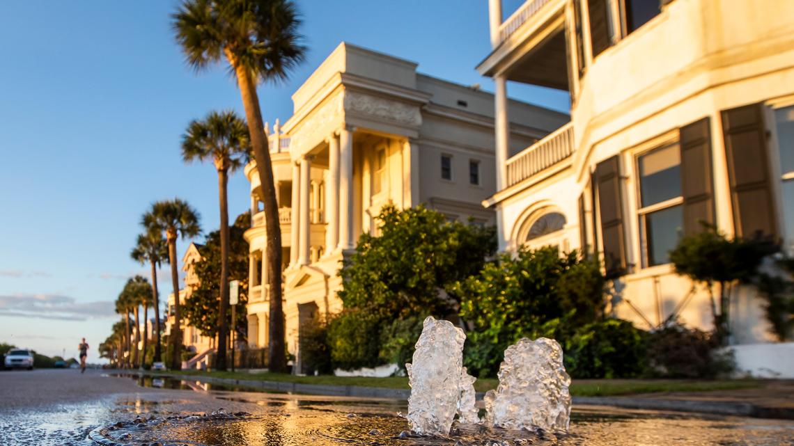A storm drain bubbles over as a king tide rolls into the Battery in Charleston in 2020.