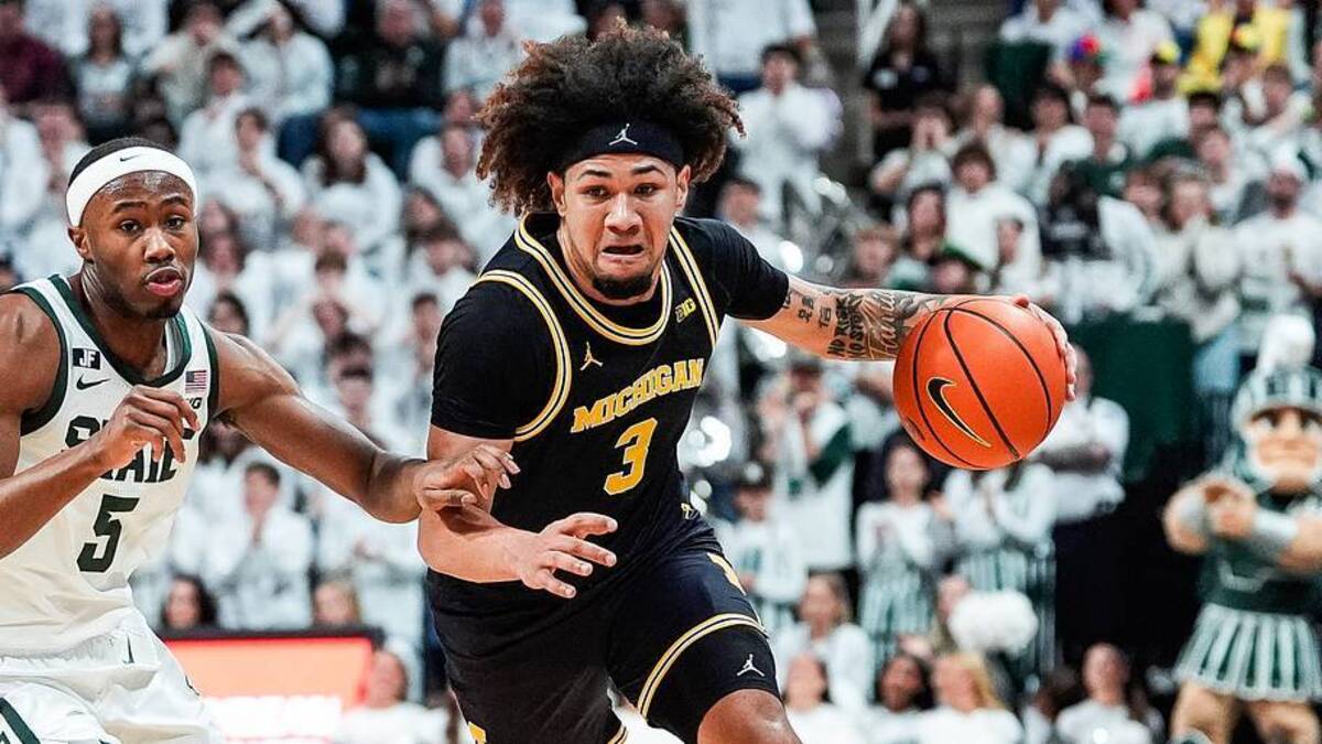  Michigan guard Tre Donaldson (3) dribbles against Michigan State guard Tre Holloman (5) during the first half at Breslin Center in East Lansing on Sunday, March 9, 2025. | USA TODAY Network via Reuters Connect 