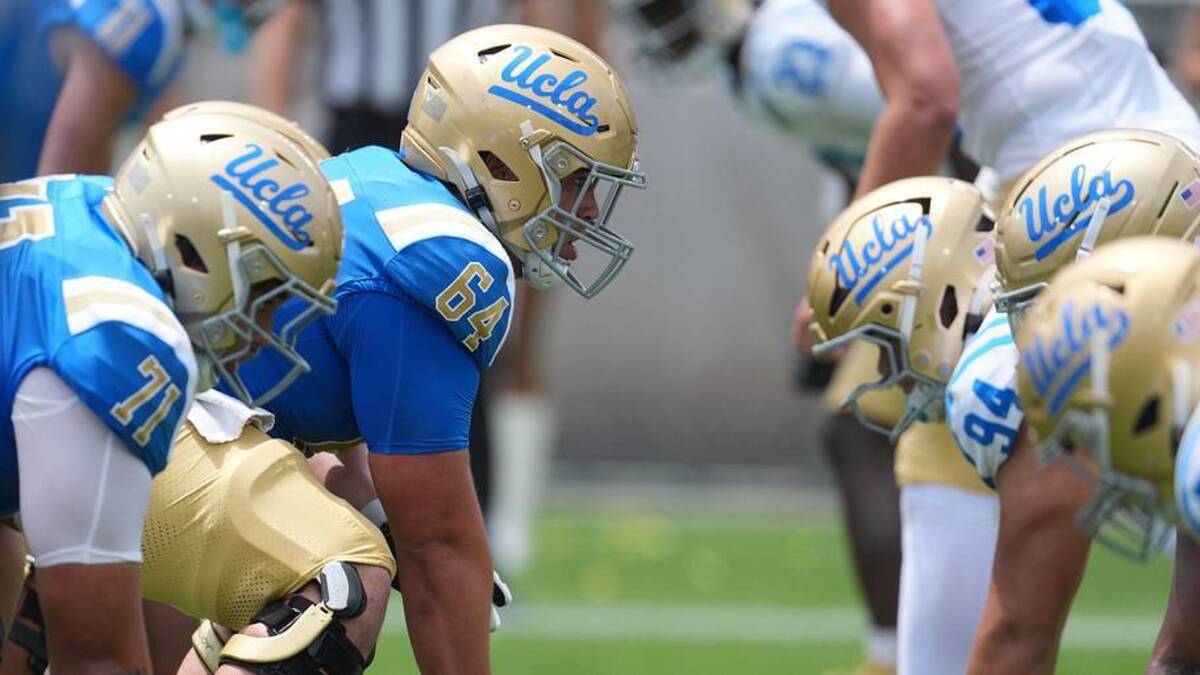  May 2, 2026; Pasadena, CA, USA; A general overall view of helmets at the line of scrimmage as UCLA Bruins center Sam Yoon (64) snaps the ball during the spring game at Rose Bowl. Mandatory Credit: Kirby Lee-Imagn Images | Kirby Lee-Imagn Images 