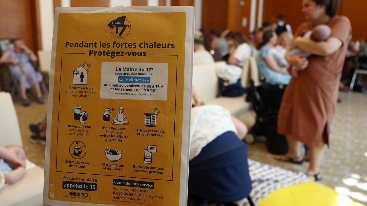 A sign reading 'During intense heat protect yourself' is seen inside an air-conditioned room open to the public inside the 17th district city hall as temperatures rise in Paris, during a heatwave affecting a majority of the country, in France, June 25, 2026. REUTERS/Alice Sacco