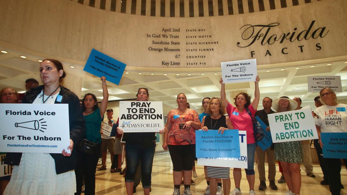 Supporters of Florida Voice For The Unborn demonstrate outside the fourth floor as legislators work on property insurance bills Tuesday, May 24, 2022, at the Capitol in Tallahassee, Fla.