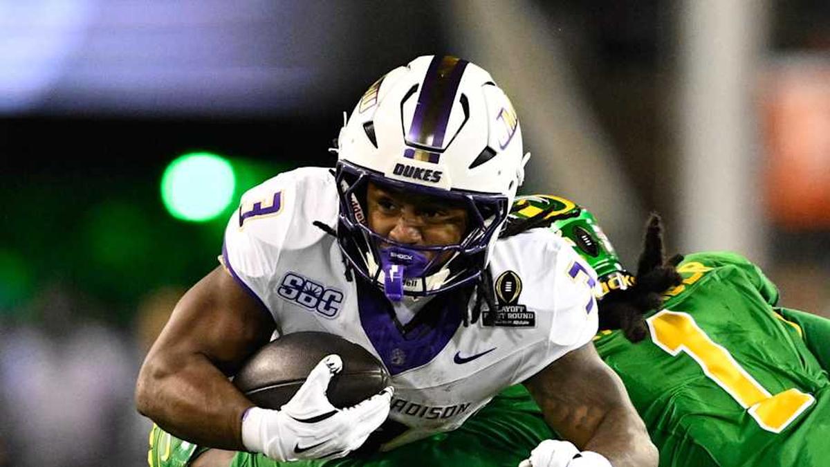  Dec 20, 2025; Eugene, OR, USA; James Madison Dukes running back Wayne Knight (3) rushes as Oregon Ducks defensive back Aaron Flowers (21) defends during the second quarter at Autzen Stadium. Mandatory Credit: Troy Wayrynen-Imagn Images | Troy Wayrynen-Imagn Images 