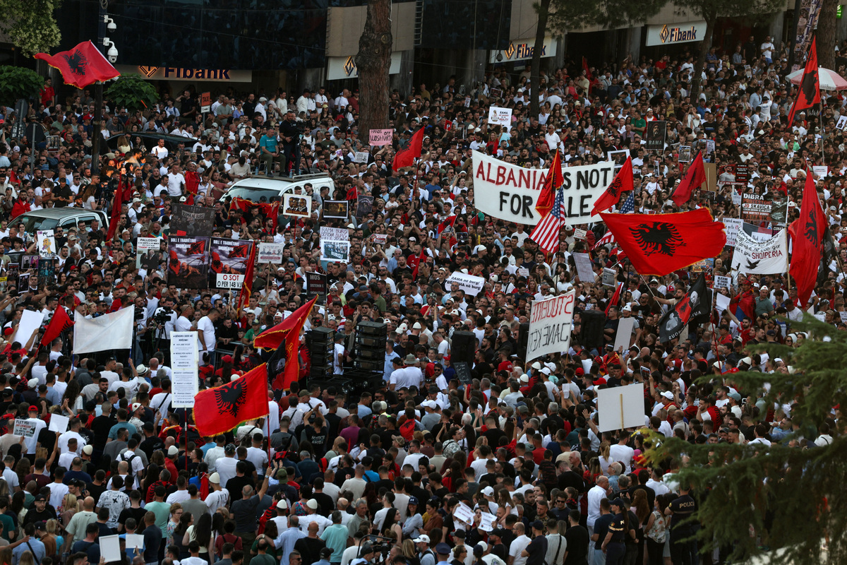Protesters wave Albanian national flags during a protest against a luxury resort, a plan by a company linked to U.S President Donald Trump's son-in-law, Jared Kushner, on an environmentally sensitive part of the Adriatic coast, in Tirana, Albania, June 10, 2026. REUTERS/Florion Goga