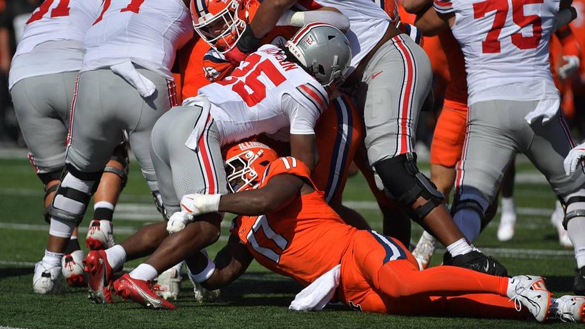  Oct 11, 2025; Champaign, Illinois, USA; Ohio State Buckeyes running back Bo Jackson (25) is tackled by Illinois Fighting Illini defensive end Gabe Jacas (17) during the first quarter at Memorial Stadium. Mandatory Credit: Ron Johnson-Imagn Images | Ron Johnson-Imagn Images 