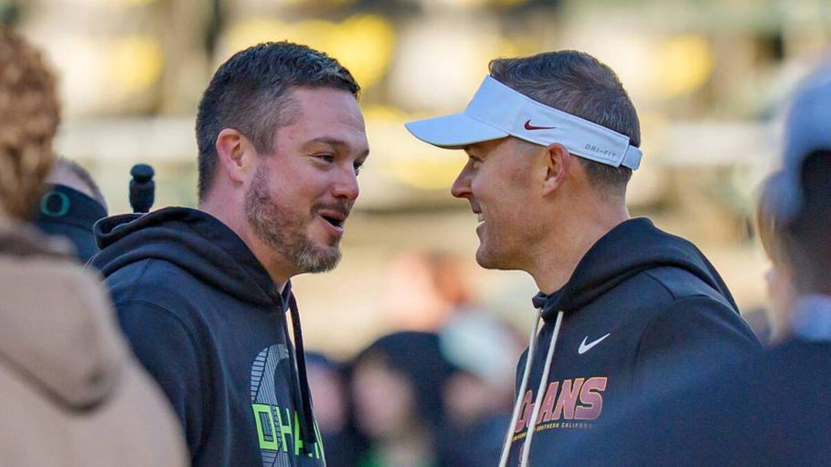  Oregon head coach Dan Lanning, left, and USC head coach Lincoln Riley shake hands before the game as the Oregon Ducks host the USC Trojans on Nov. 22, 2025, at Autzen Stadium in Eugene, Oregon. | Ben Lonergan/The Register-Guard / USA TODAY NETWORK via Imagn Images 