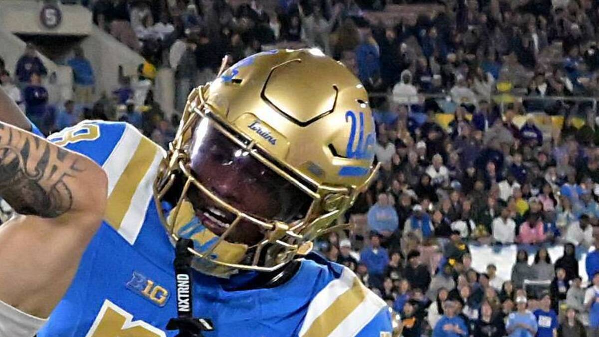  Nov 22, 2025; Pasadena, California, USA; UCLA Bruins defensive back Scooter Jackson (28) breaks up a pass intended for Washington Huskies wide receiver Audric Harris (13) in the end zone during the first half at the Rose Bowl. Mandatory Credit: Jayne Kamin-Oncea-Imagn Images | Jayne Kamin-Oncea-Imagn Images 