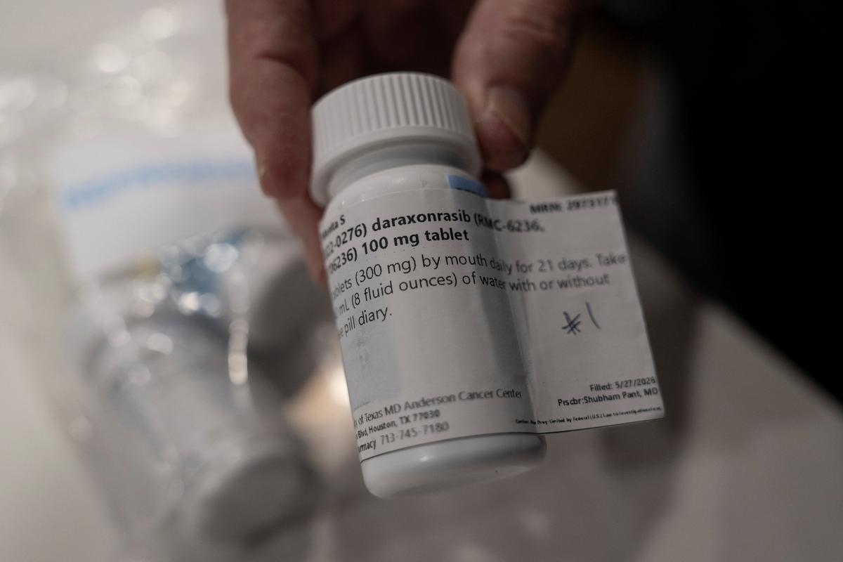 Menta "Steve" Wallace shows a bottle of daraxonrasib, Revolution Medicine?s pancreatic cancer drug, at his home in The Woodlands, Texas, U.S., May 29, 2026.   REUTERS/Danielle Villasana