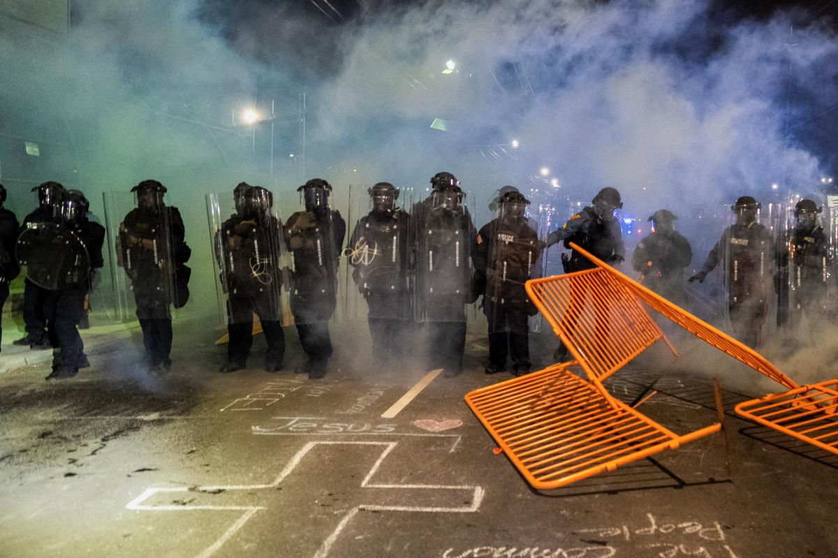 New Jersey State Policemen in riot gear operate amidst the deployed tear gas as protestors remain gathered outside Delaney Hall detention center, in Newark, New Jersey, U.S., May 29, 2026. REUTERS/David Delgado