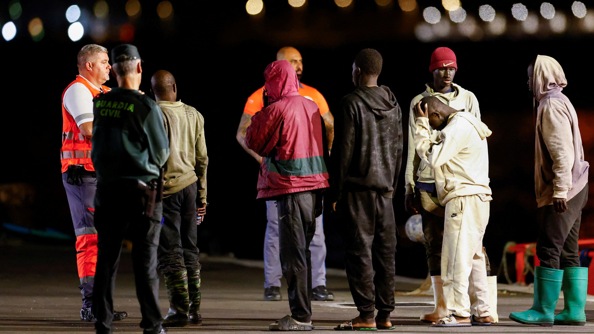 Migrants wait to be attended to after disembarking from a Spanish coast guard vessel at the port of Arguineguin, on the island of Gran Canaria, Spain, April 21, 2026. REUTERS/Borja Suarez