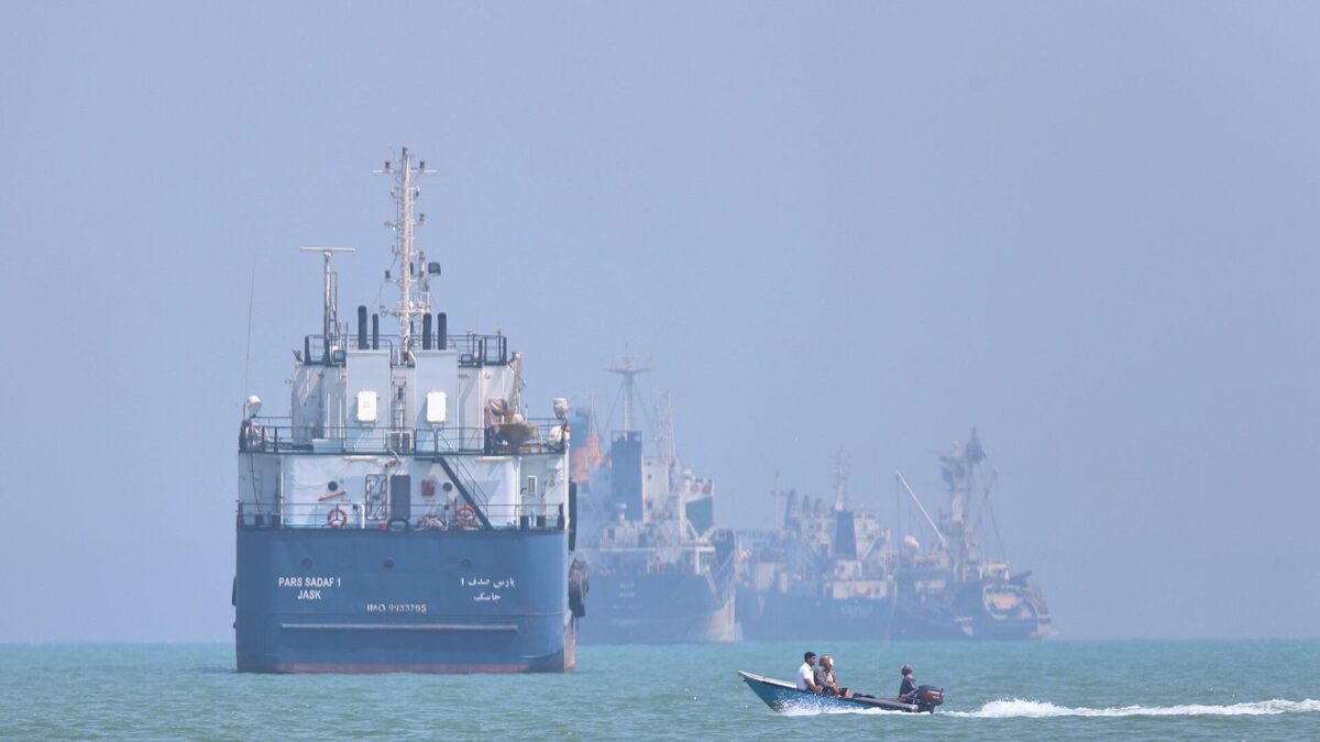 A small motorboat passes anchored vessels in the Strait of Hormuz off Bandar Abbas, Iran, on June 11, 2026. 