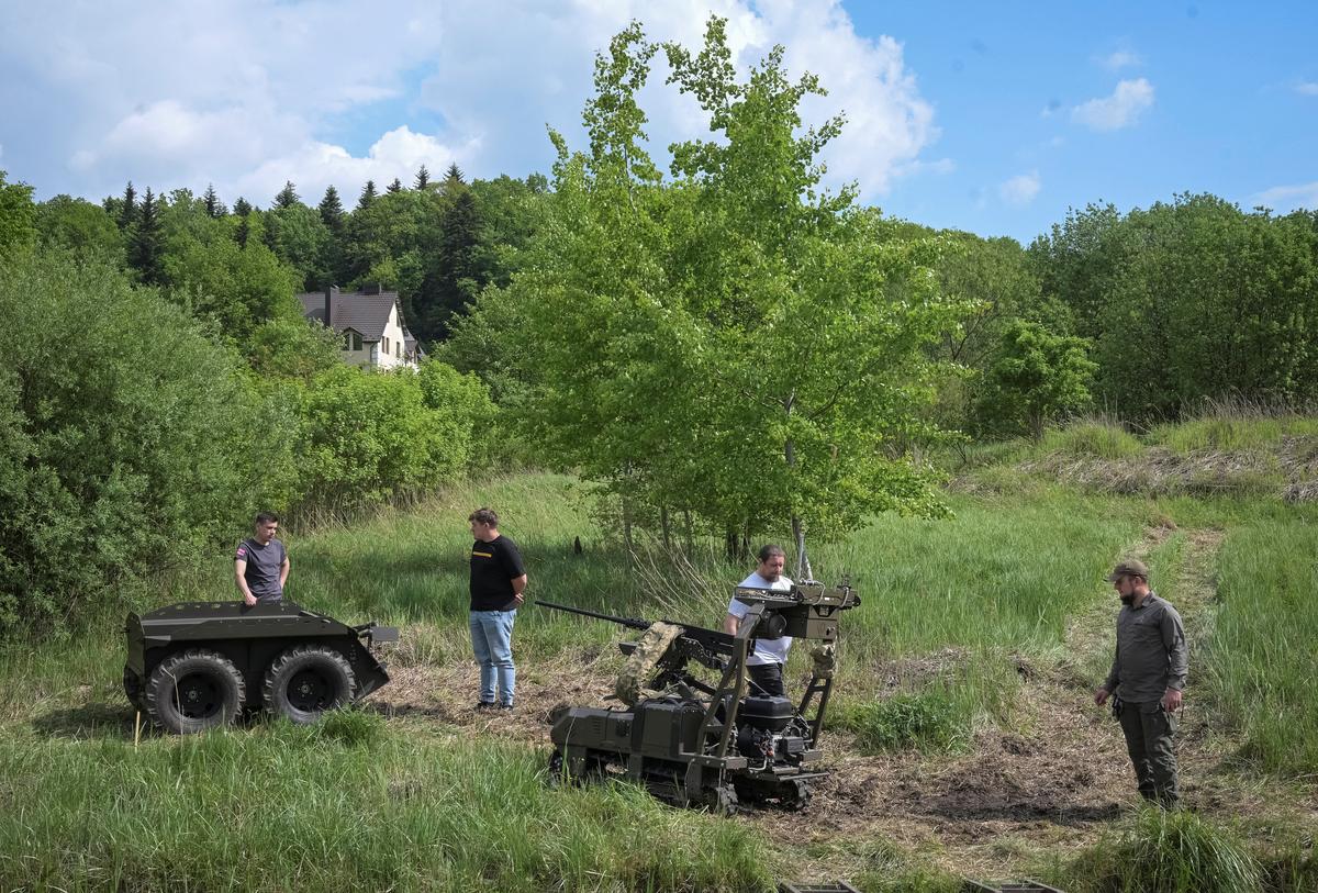 Participants of the Wild Drones competition appear near unmanned ground vehicles (UGVs) during a race, amid Russia's attack on Ukraine, in the town of Truskavets, Lviv region, Ukraine May 20, 2026. REUTERS/Stringer