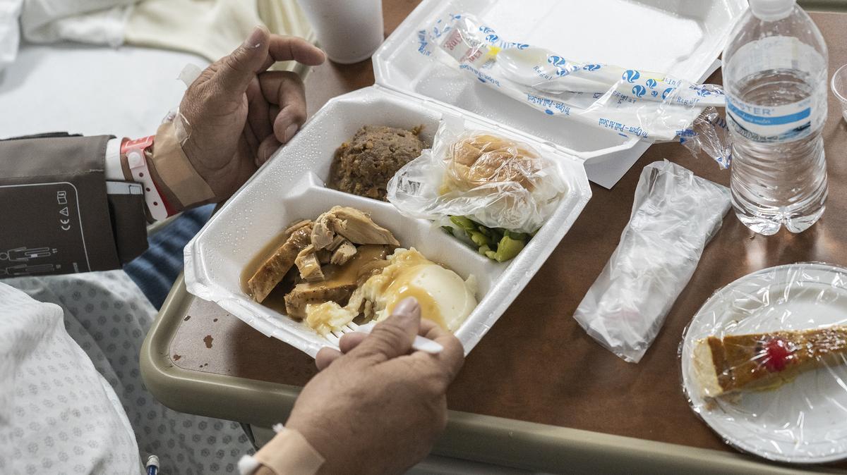 A patient eats a meal with turkey and a pie in the COVID-19 intensive care unit (ICU) during Thanksgiving at the United Memorial Medical Center on Nov. 26, 2020, in Houston, Texas.  (Go Nakamura/Getty Images/TNS)