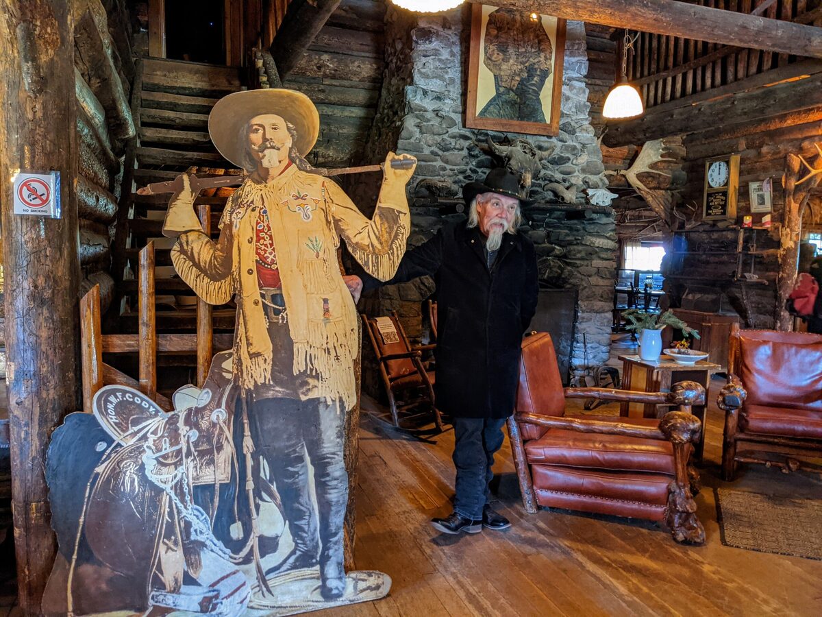  Buffalo Bill impersonator and historian Ron Pearce stands next to a cut-out of Buffalo Bill Cody. Photo credit: Cindy Richards 