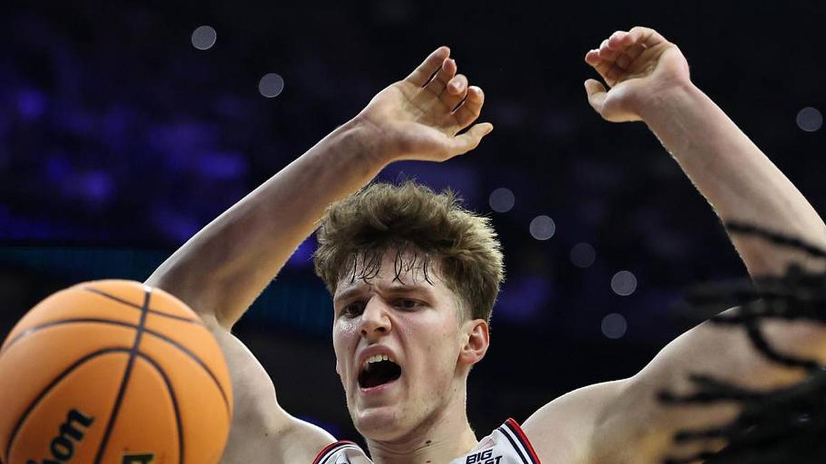  Mar 22, 2026; Philadelphia, PA, USA; UConn Huskies center Eric Reibe (12) dunks the ball against the UCLA Bruins in the first half during a second round game of the men's 2026 NCAA Tournament at Xfinity Mobile Arena. Mandatory Credit: Bill Streicher-Imagn Images | Bill Streicher-Imagn Images 