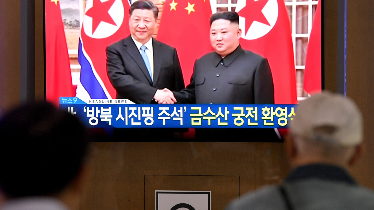 People watch a television news screen showing North Korean leader Kim Jong Un shaking hands with Chinese President Xi Jinping, at Seoul railway station in Seoul on June 20, 2019. North Korean leader Kim Jong Un welcomed Chinese President Xi Jinping to Pyongyang on June 20, on a historic visit to burnish an uneasy alliance, with the two men each facing challenges of their own with US President Donald Trump. (Jung Yeon-Je/AFP/Getty Images/TNS)