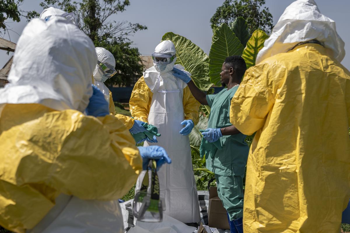 Health workers get ready to handle a body of suspected Ebola victim in the mining town of Mongbwalu, Democratic Republic of Congo, May 25, 2026. In a remote gold mining town at the epicenter of the Ebola outbreak, medical workers struggle to beat back a surge of deaths and infections. (Arlette Bashizi/The New York Times)