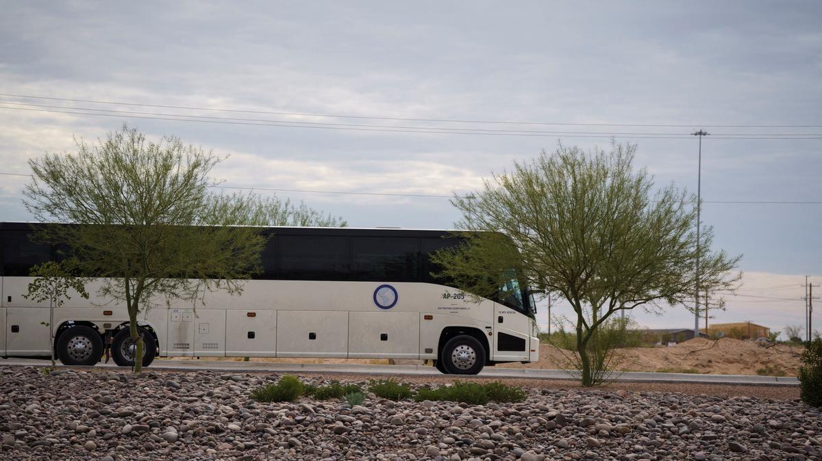 A bus used to transport detainees of Immigration and Customs Enforcement exits Camp East Montana, an ICE detention facility designed to house up to 5,000 migrants at Fort Bliss in El Paso, Texas, in 2025. Three people have died in the nine months since it opened, according to a lawsuit.