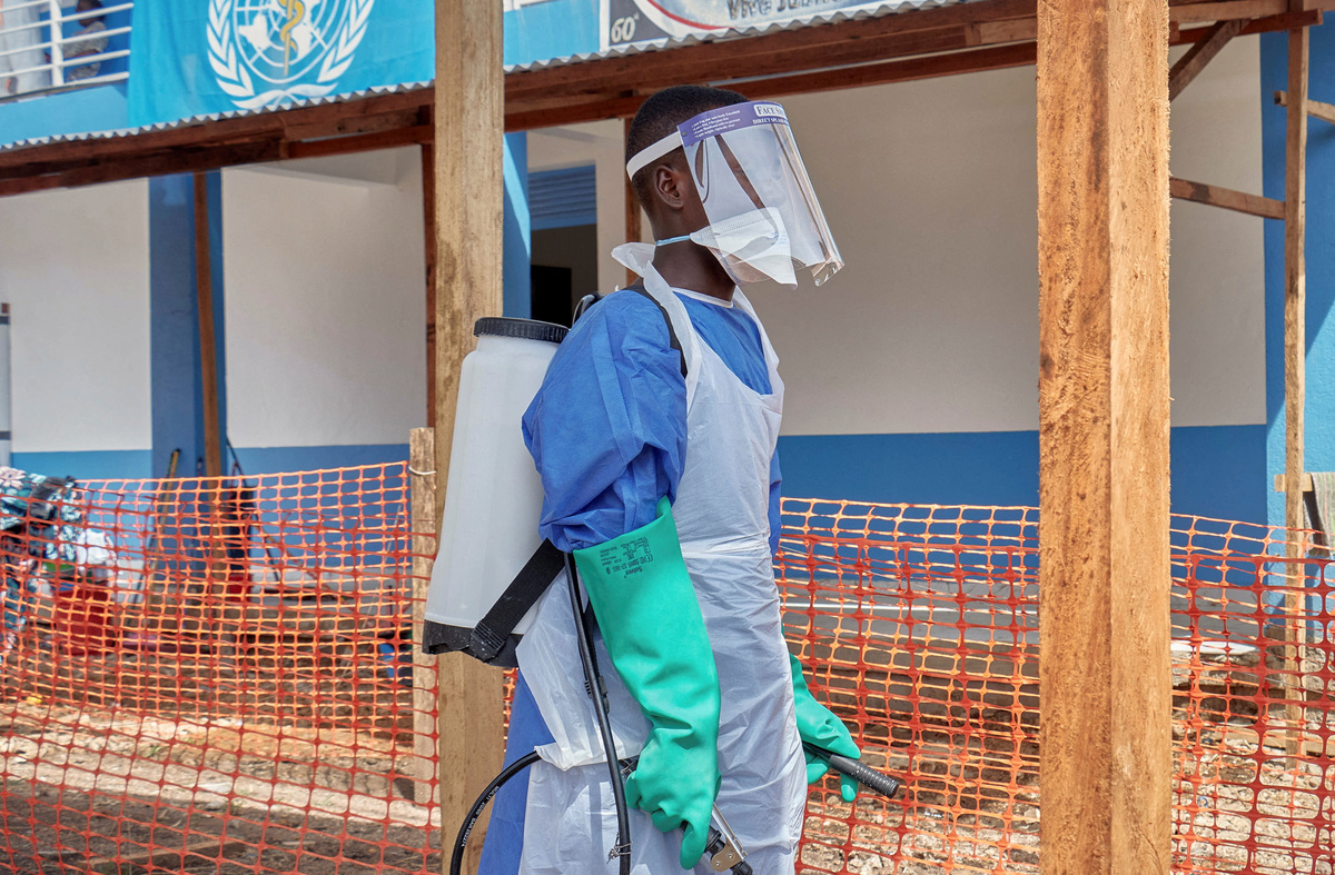 A Congolese medical worker walks at the Centre Medical Evangelique (CME) within the secured Ebola response zone, as aid agencies intensify efforts to contain the Ebola outbreak involving the Bundibugyo strain, in Hoho commune of Bunia town, Ituri province, Democratic Republic of Congo, June 9, 2026. REUTERS/Gradel Muyisa Mumbere