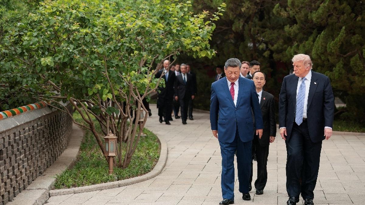 U.S. President Donald Trump walks with Chinese President Xi Jinping while leaving after a visit to the Zhongnanhai Garden in Beijing, China, May 15, 2026. REUTERS/Evan Vucci/Pool